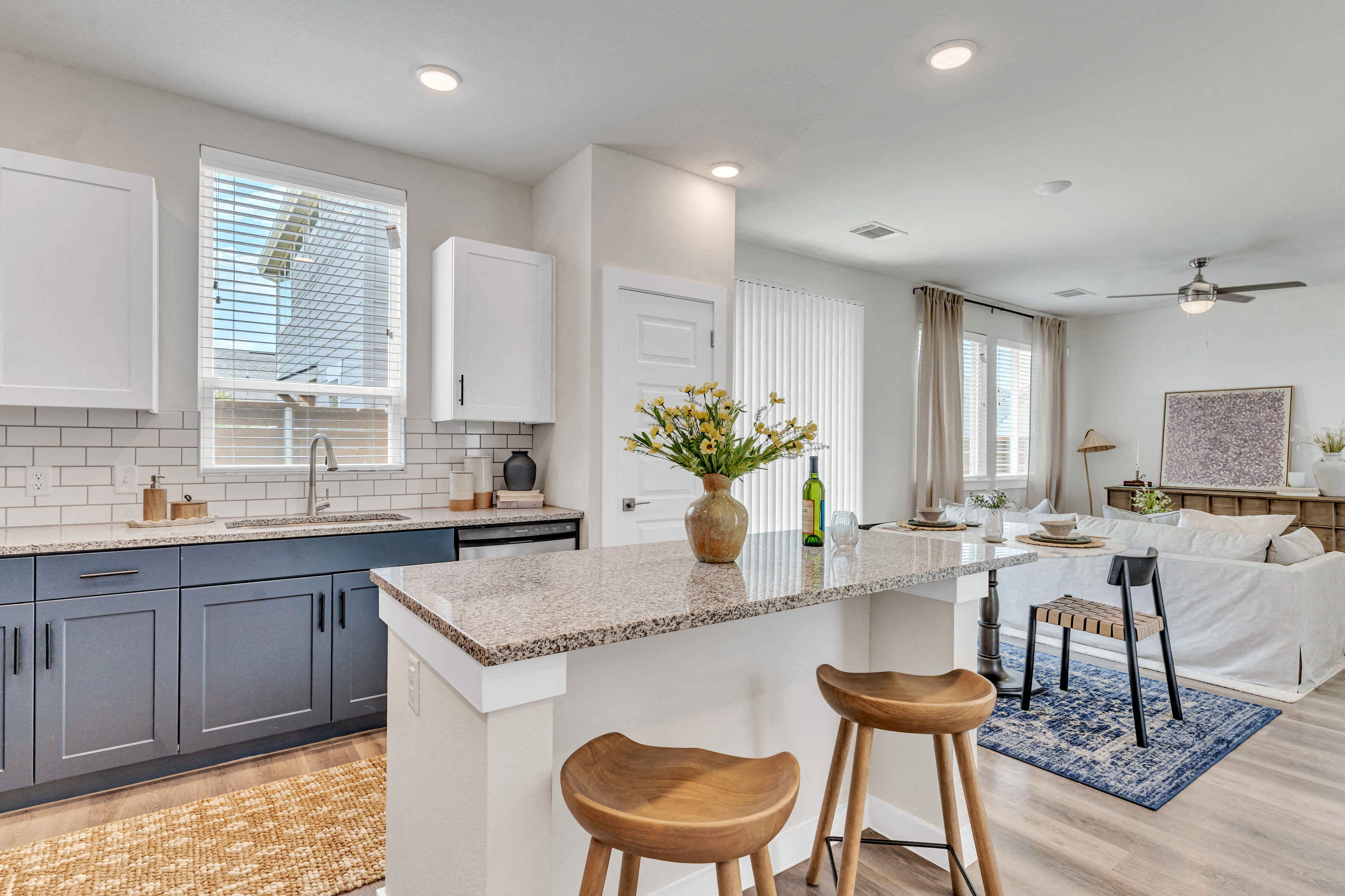 a kitchen with an island and a living room with a couch